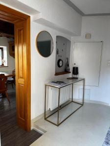 a living room with a table and a mirror at Haus Wildblick in Fladnitz an der Teichalm