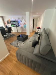a large gray couch in a living room at Apartamento AC T2 Pombal in Pombal
