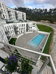 an apartment complex with a swimming pool in a courtyard at Apartamento AC T2 Pombal in Pombal