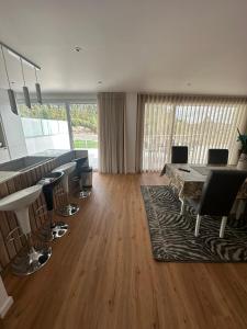 a large living room with a table and chairs at Apartamento AC T2 Pombal in Pombal