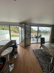 a living room with glass doors and a table and chairs at Apartamento AC T2 Pombal in Pombal