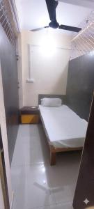 a small room with a bed and a ceiling at Shraddha Hotel in Alīgarh