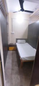 a small room with a bed in a room at Shraddha Hotel in Alīgarh +3 photos