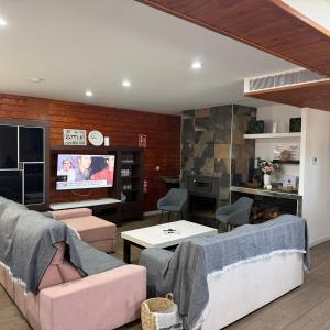 a living room with a couch and a tv at Casa Cristea Barranda in Caravaca de la Cruz