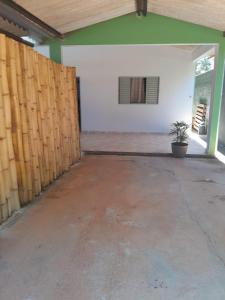 an empty garage with a wooden fence and a plant at Casa Mirante da Lua in Cavalcante