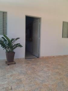 a potted plant sitting in front of a door at Casa Mirante da Lua in Cavalcante