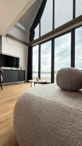 a bedroom with a large bed with a large window at Sosina Dreams in Jaworzno