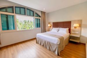 a bedroom with a large bed and a large window at Viona Beach Hotel - Marina Phu Quoc in Phú Quốc +63 photos
