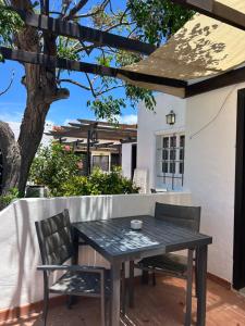 a black table and chairs on a patio at La Concha del Mar in Corralejo