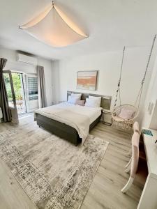 a bedroom with a swinging bed and a swing chair at Room TARA Malinska in Malinska