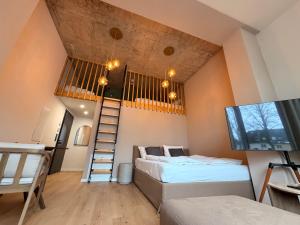 a bedroom with two beds and a loft at Villa Weitmar - Apartments und Private Spa in Bochum