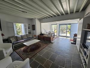 a living room with a couch and a table at Villa Thalassa - Vathy in Sifnos