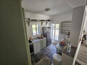 a kitchen with a sink and a refrigerator at Villa Thalassa - Vathy in Sifnos