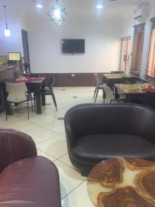 a waiting room with chairs and a couch and tables at Trendy Inn limited in Lagos