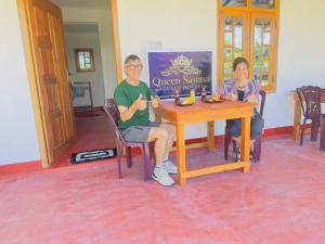a man and a woman sitting at a table at QUEEN SASTINA guest house in Nilaveli