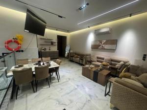 a living room with a couch and a table at فلة جديدة راقية بمسبح داخلي Luxury villa with indoor pool in Taif