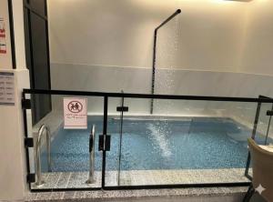 a swimming pool in a building with a sign on it at فلة جديدة راقية بمسبح داخلي Luxury villa with indoor pool in Taif