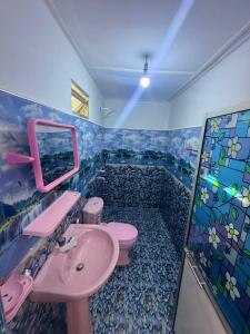 a bathroom with a pink sink and a toilet at QUEEN SASTINA guest house in Nilaveli +30 photos
