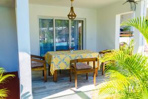 a table and chairs on the porch of a house at Villa Bako Hôtel in Nosy Be
