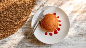 a plate with a piece of cake with berries on it at Ocha Bajo Homestay in Komodo Labuan Bajo Airport
