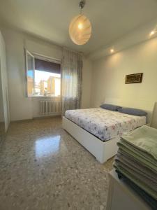 a bedroom with a bed and a window at Casa vacanza Dominga in Marotta