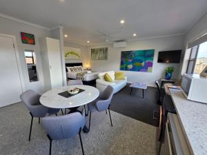 a living room with a couch and a table at Aart Apartments in Port Lincoln
