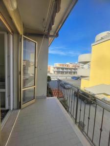 an open door on a balcony with a view at Casa vacanza Dominga in Marotta +7 photos