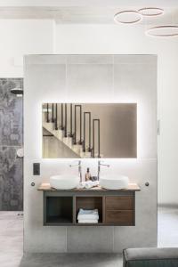 a bathroom with two sinks and a mirror at Villa Weitmar - Apartments und Private Spa in Bochum