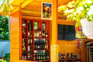 a wooden bar with a lot of bottles of alcohol at Eva Residence Arusha in Arusha