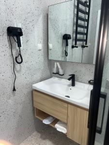 a bathroom with a sink and a mirror at Beshik Apartment 2 in Samarkand +12 photos