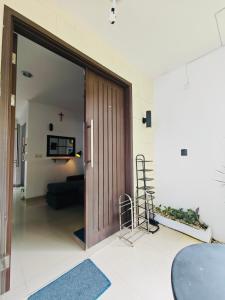 a large wooden door in a living room with a ladder at Flo's Transit Home in Manado