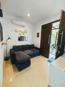 a living room with a couch and a table at Flo's Transit Home in Manado