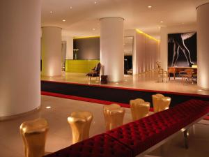 a lobby with a red bench and a dining room at St Martins Lane London in London