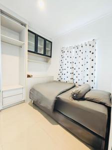 a bedroom with a bed and a window at Flo's Transit Home in Manado