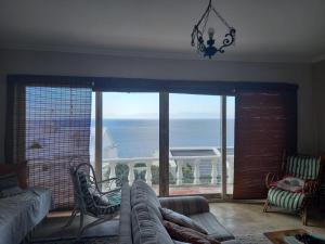 a living room with a couch and a view of the ocean at Oceanview Sunrise Beach Villa in Rocklands