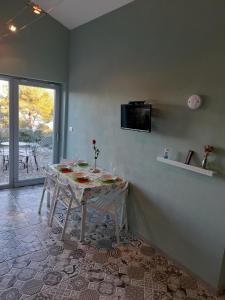 a room with a table and a tv on a wall at Home Lotus Flower in Labin