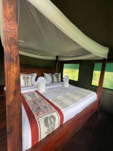 a bedroom with a bed in a tent at Tangi Elephant Camp in Pakwach East
