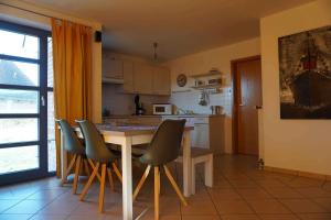 a kitchen with a table and chairs in it at Ferienhaus Rieke in Friedrichskoog-Spitze
