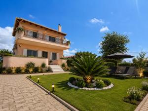 a house with a garden in front of it at Casa Rosa Ammoudia in Ammoudia