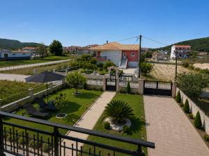 a view of a courtyard with a patio and a garden at Casa Rosa Ammoudia in Ammoudia
