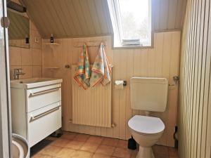 a small bathroom with a toilet and a sink at Familie Hensen - FeWo mit überdachter Terrasse im Ortskern von Tarp in Tarp +12 photos