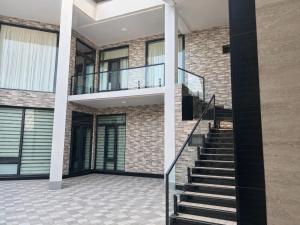 a house with a staircase and a brick wall at Beshik Apartment 2 in Samarkand