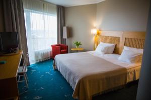 a hotel room with a bed and a television at Georg Ots Spa Hotel in Kuressaare +39 photos