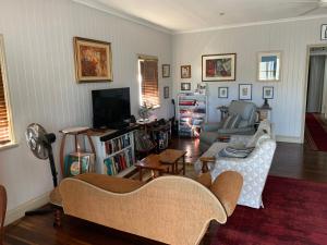 a living room with a couch and a tv at Kinnoull in Brisbane