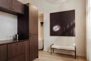 a bathroom with a bench and a painting on the wall at Sola Studios in Margaret River Town +53 photos