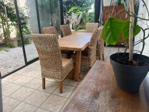 a wooden table and chairs on a patio at La Lone 1870 in La Roche-de-Glun +22 photos