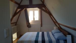 a bedroom with a bed and a window at La truffière in Belvès