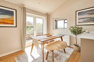 a dining room with a table and chairs and a window at Host & Stay - Stille House in Beadnell