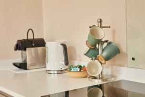 a kitchen counter with cups and a coffee maker at Host & Stay - Stille House in Beadnell