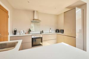 a kitchen with a sink and a stove top oven at Host & Stay - Stille House in Beadnell